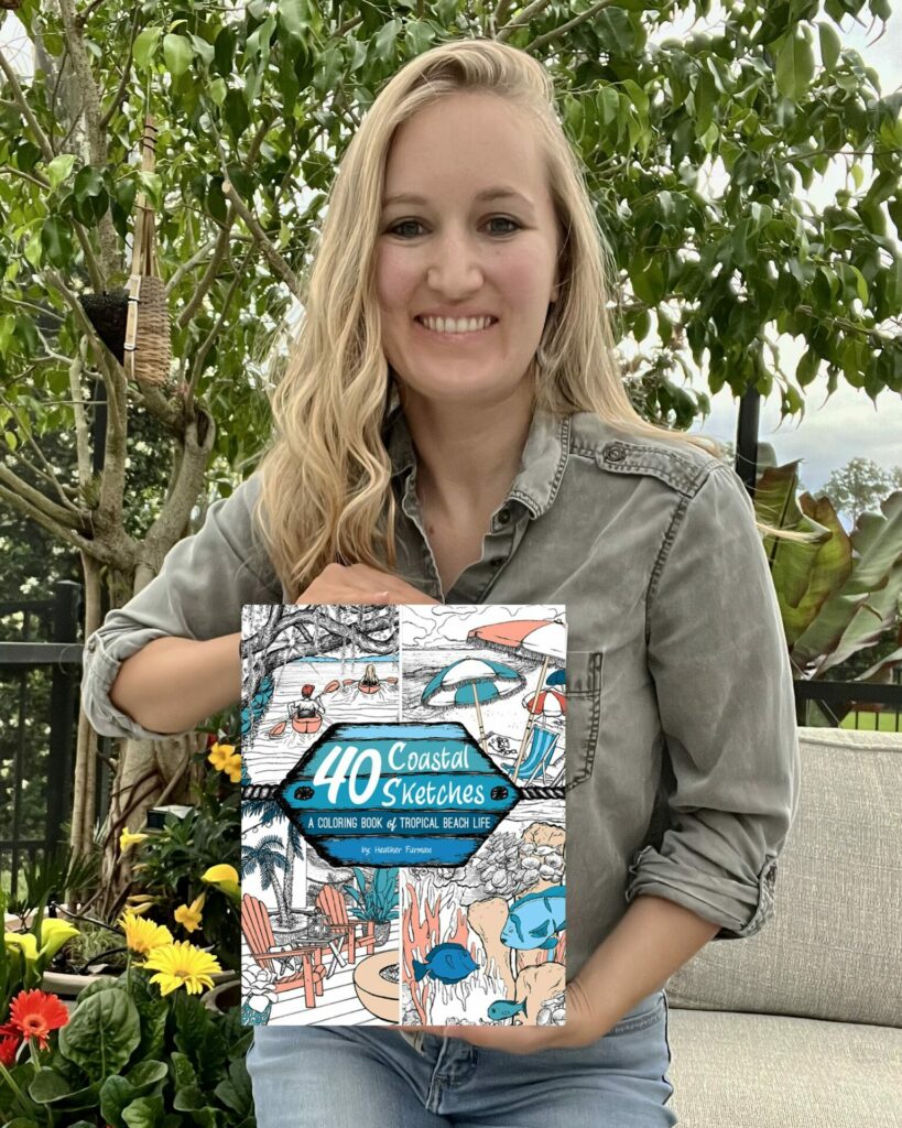 Heather holding up coloring book 40 Coastal Sketches